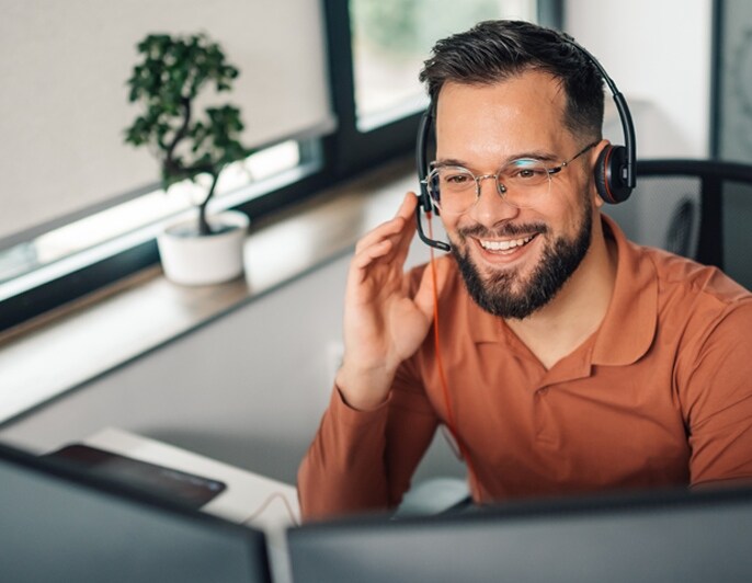 Customer service representative assisting a customer with a headset.