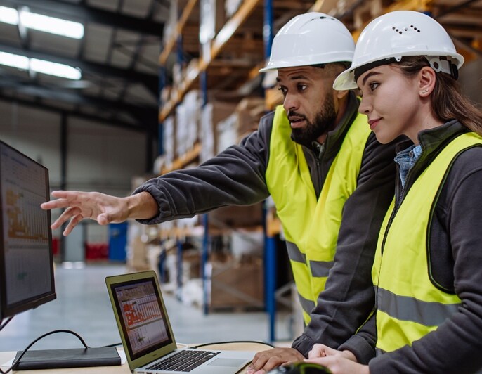 Warehouse staff reviewing inventory and operational data.
