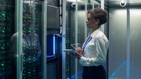 Technician monitoring servers in a data center