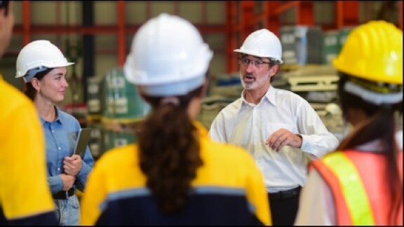 Workers participating in a warehouse safety briefing